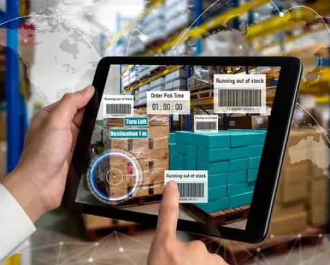 Tablet displaying real-time warehouse management software with inventory tracking and stock alerts, emphasizing automation and efficiency in large corporate warehouses.