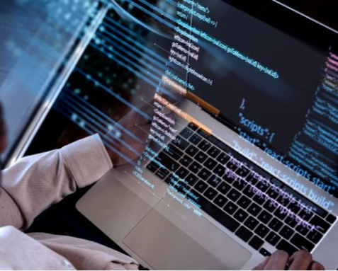 A developer working on a laptop with code visible on the screen, highlighting Samyak Infotech's custom AngularJS development services tailored to meet specific business goals and enhance operations with competitive features.