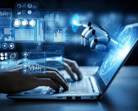 Hands typing on a laptop with holographic data transformation visuals, including a robotic hand assisting, representing MuleSoft certified developers performing accurate data transformation between different formats and systems.