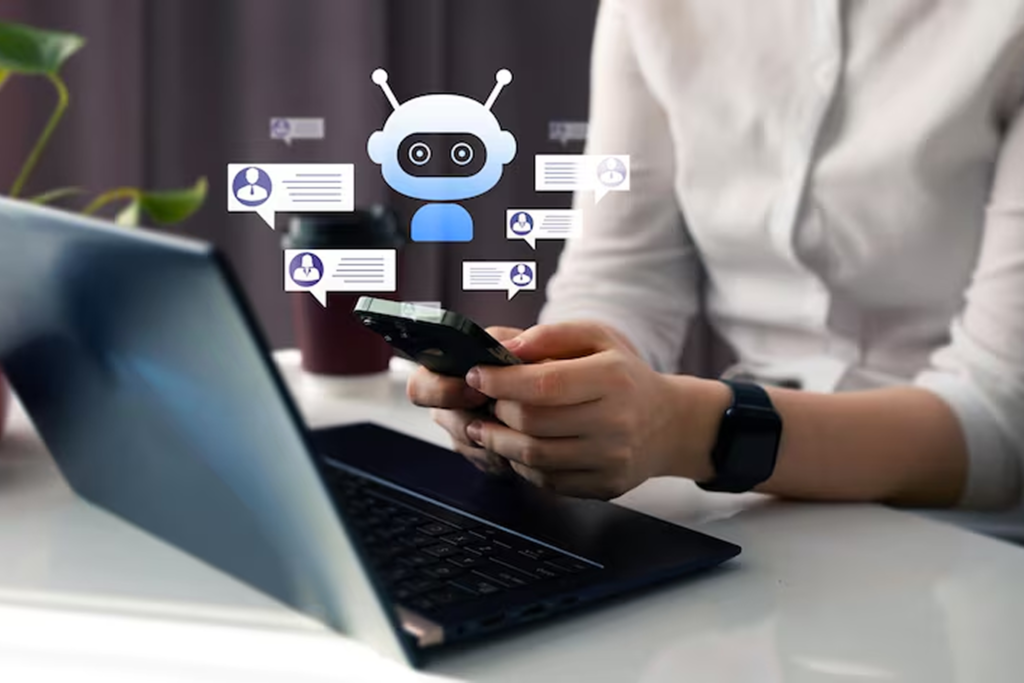 Person using smartphone with floating chatbot icons and laptop in view, representing NLP consultant services for building conversational AI and chatbots that understand intent and learn from interactions.