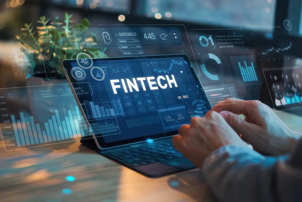 Person using tablet with “FINTECH” displayed on screen, surrounded by futuristic financial analytics and charts, representing AI copilot development services enhancing data-driven decision-making in finance and banking sectors.
