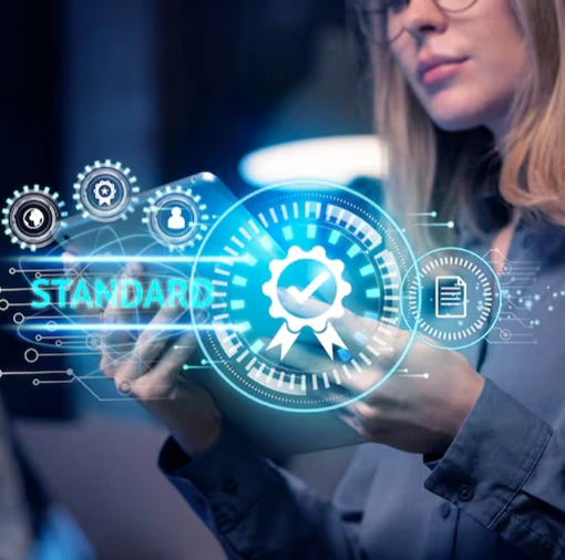 Woman using digital interface with quality certification icon, representing enterprise AI solutions using computer vision for defect detection, production monitoring, and compliance with quality standards to boost efficiency and reduce waste