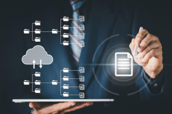 A professional wearing augmented reality glasses interacts with a holographic display of industrial machinery, representing machine learning development services in manufacturing for process optimization, quality control, and predictive maintenance.