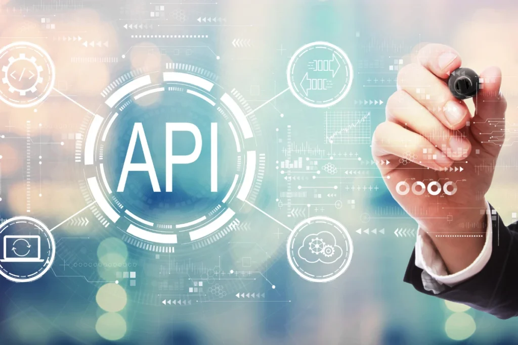 A hand holding a pen near a digital representation of an API, with connected systems like cloud services, analytics, and payment gateways, illustrating seamless API integration for improved functionality.